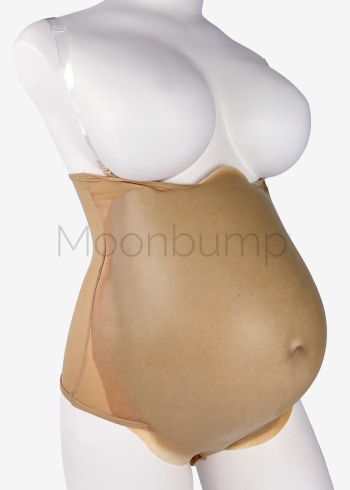 7-8 Month silicone large fake pregnant belly by Moonbump, in colour M6 'light brown', shown on a mannequin